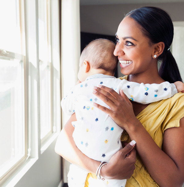 A mother tenderly holding her newborn baby